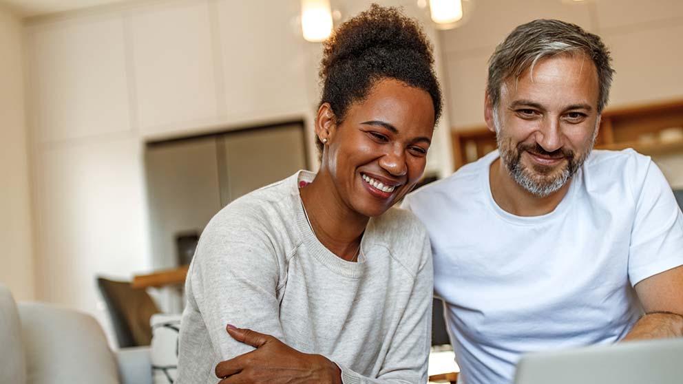 man and woman looking at a laptop